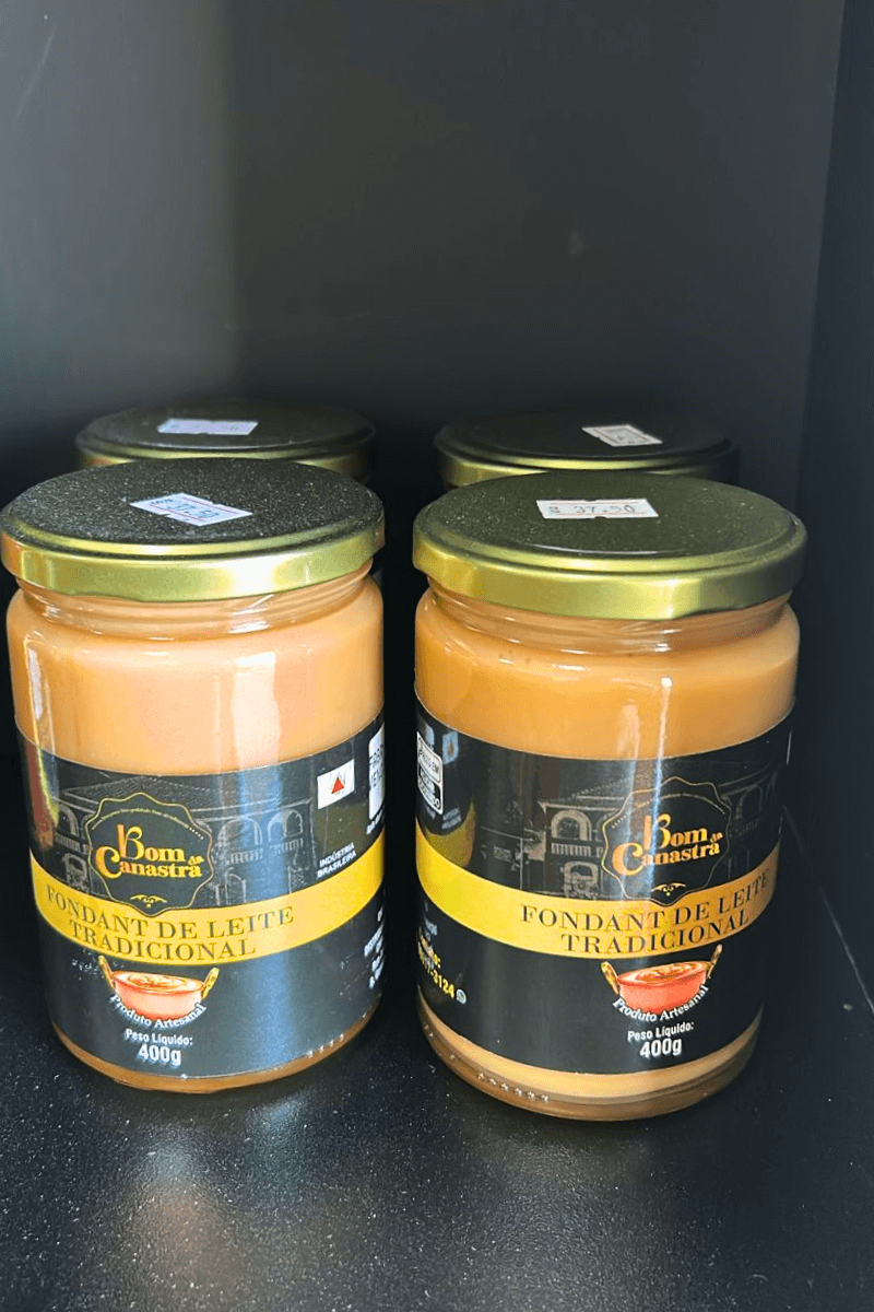 Potes de vidro de Fondant de Leite Tradicional Bom da Canastra com 400g, exibindo a cor caramelo dourada e textura cremosa, com rótulo preto e dourado destacando a produção artesanal.